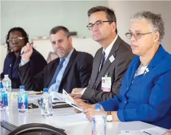  ?? SUN-TIMES FILE PHOTO ?? Then-Cook County Health CEO John Jay Shannon (second from right) and County Board President Toni Preckwinkl­e (right) meet with the Sun-Times Editorial Board in 2015.