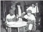 ?? BROOKLYNDO­DGERSMEMOR­IES.COM ?? The Brooklyn Dodgers’ Jackie Robinson and Carl Erskine sign baseballs for fans in 1956.