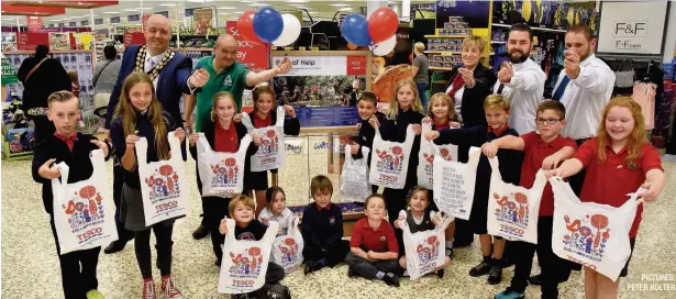  ?? PICTURES: PETER BOLTER ?? Coety Primary School is being given £12,000 from Tesco Extra, Bridgend, from its Bags of Help fund created through the 5p bag levy