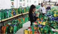  ?? MATT OLSON ?? Volunteer Kaitlyn Cho helps set out food hampers at the Saskatoon Food Bank and Learning Centre on Saturday.