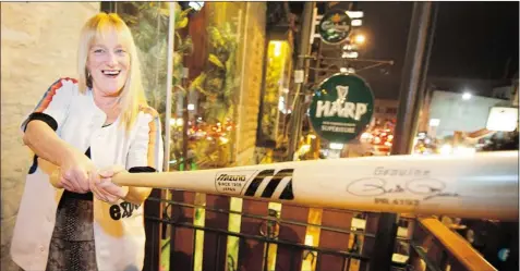  ?? PETER MCCABE THE GAZETTE ?? Katie Hynes, with a Pete Rose bat from Japan that she donated to raise money for the Sarah Cook Fund, says people still call her “Madame Expos.”