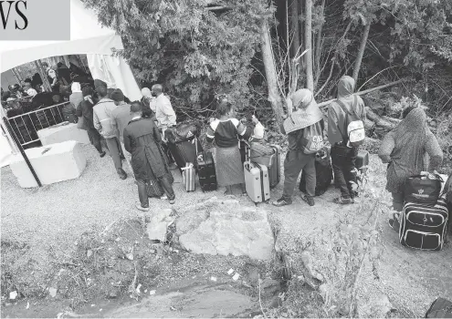  ?? GEOFF ROBINS / AFP / GETTY IMAGES FILES ?? The backlog of asylum cases in Canada is nearing 65,000 people. Here, crossers queue at the border near Champlain, N.Y., in August 2017.