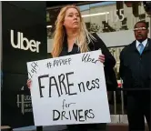  ?? KARL MONDON BAY AREA NEWS GROUP ?? Erica Mighetto, a ride-hail driver for Lyft, joins a protest in front of Uber headquarte­rs in San Francisco in May.