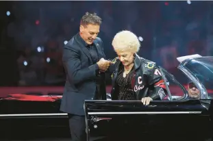  ?? ?? Chris Chelios and his mother, Sue, attend a ceremony to retire his No. 7 jersey on Sunday.