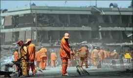  ?? RAHMAT GUL / ASSOCIATED PRESS ?? Municipal workers sweep a road in front of the German Embassy in Kabul, Afghanista­n, after a suicide attacker’s truck exploded in the capital city’s heavily guarded diplomatic quarter during morning rush hour Wednesday.