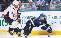  ?? AFP ?? Dan Girardi (right) of the Tampa Bay Lightning bids to control the puck against Alex Ovechkin of Washington Capitals in Game One of the Eastern Conference Finals in Tampa, Florida.