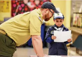  ?? Amy Newman / The Record via Associated Press ?? Scout leader Kyle Hackler and Joe Maldonado, the first openly transgende­r member of the Boy Scouts, look over the boy’s applicatio­n to Pack 87 in Maplewood, N.J. “This is so fun; I’m so proud,” the 9-year-old boy said.