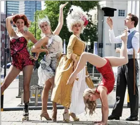  ??  ?? MEMBERS of the Black Cat Cabaret company limber up for their summer show by performing amid the black cat statues outside the former Carreras cigarette factory in Mornington Crescent. The company presents Nocturne at London Wondergrou­nd on the South...