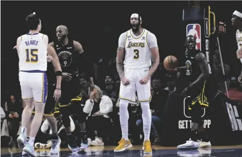  ?? AP PHOTO/JAE C. HONG ?? Los Angeles Lakers’ Anthony Davis (3) reacts after making a basket during the second half of an NBA basketball game against the Golden State Warriors on Sunday in Los Angeles.