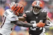  ?? NICK CAMMETT / ASSOCIATED PRESS ?? Nick Chubb tries to break free from Bengals defensive back Michael Thomas on Jan. 9 in Cleveland. The Browns host Cincinnati on Oct. 31 for “Monday Night Football.”