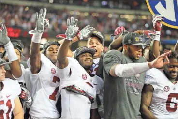  ?? John Bazemore/AP ?? Alabama players celebrate victory against Florida after the Southeaste­rn Conference championsh­ip NCAA college football game, Saturday, Dec. 3, 2016, in Atlanta. Alabama won 54-16.