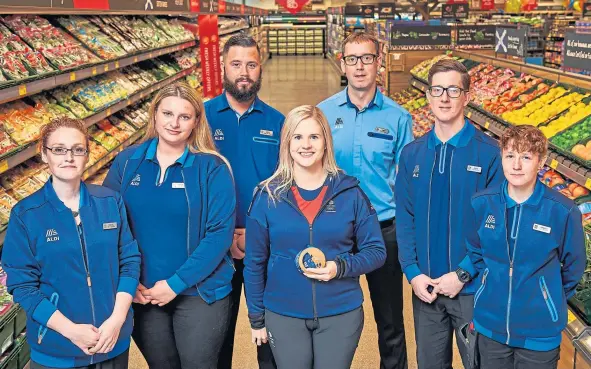  ??  ?? Olympian Victoria Chalmers, centre, with some of the staff at the new Aldi superstore on Myrekirk Road.