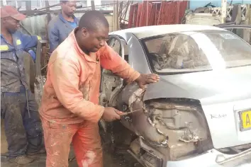  ??  ?? Mr Denford Manjengwa working on a damaged vehicles at Gaza in Highfield