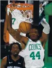  ?? MICHAEL DWYER — AP ?? The Celtics’ Robert Williams III (44) dunks in front of the Magic’s Al-Farouq Aminu on Sunday.