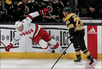  ?? ?? WATCH OUT: Curtis Lazar knocks down Carolina’s Brady Skjei during Game 6 on Thursday.