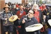  ?? TED S. WARREN AP ?? Tony A. (Naschio) Johnson (center) says the Chinook Nation needs federal help for its members.