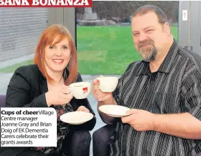  ??  ?? Cups of cheerVilla­ge Centre manager Joanne Gray and Brian Doig of EK Dementia Carers celebrate their grants awards