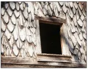  ??  ?? Fish-scale shingles add a touch of charm on each end of the house.