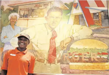  ?? Dylan Aguilar / Houston Chronicle ?? In front of a retro painting at the Silber Road Whataburge­r in west Houston is Amelia Demery.