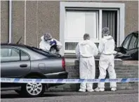  ??  ?? Police forensic officers at the crime scene