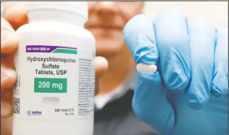  ?? — REUTERS FILES ?? The drug hydroxychl­oroquine is displayed by a pharmacist.