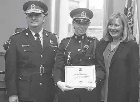  ?? ADAM MACINNIS/THE NEWS ?? Claire Corkum-Timmons became the first female officer promoted to the rank of corporal. Presenting her with the promotion are Police Chief Eric MacNeil and New Glasgow Mayor Nancy Dicks.