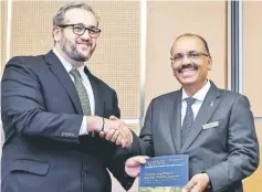  ??  ?? Ali shakes hand with Faris H. Hadad-Zervos of World Bank Malaysia upon receiving the new World Bank Report at Bank Negara Malaysia in Kuala Lumpur. —Bernama photo