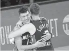  ?? KEVIN C. COX/GETTY IMAGES ?? Tyler Herro and Goran Dragic embrace after the Heat defeated the Celtics in Game 4 of the Eastern Conference finals.