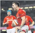  ??  ?? Red alert: George North celebrates one of his two tries for Wales