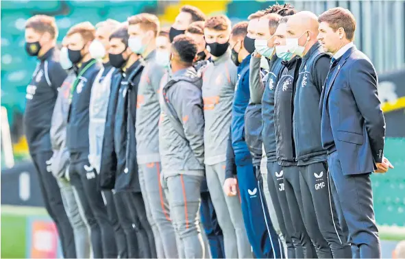  ??  ?? Rangers boss Steven Gerrard stands to support the fight against racism with his backroom staff and substitute­s before the Celtic Park clash.
