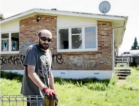  ??  ?? Barry Skinner removes rubbish from his friend’s investment property that has been empty for more than six years.