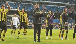  ?? ?? Jurgen Klopp and his Borussia Dortmund players celebrate after knocking Real Madrid out of the UEFA Champions League at the semi-final stage in 2013.