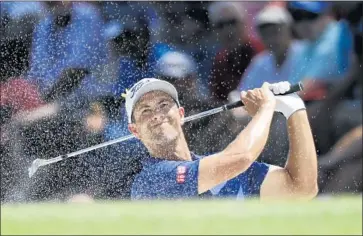  ?? Brynn Anderson Associated Press ?? ADAM SCOTT, who won the Masters in 2013 for his only major title, blasts out of a bunker on the ninth hole during a round of 65. “I felt like the younger Adam Scott swinging the golf club,” said the 38-year-old.