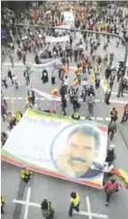  ?? — AP ?? HAMBURG: Protesters carry a banner with the image of the imprisoned Kurdish leader Abdullah Ocalan at the ‘Borderless Solidarity rather than G20’ demonstrat­ion in Hamburg, Germany yesterday.