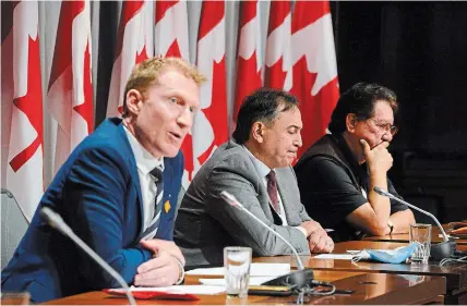  ?? SEAN KILPATRICK THE CANADIAN PRESS ?? Marc Miller, left to right, Perry Bellegarde, and former Grand Chief and elder Mike Mitchell, Mohawk Territory of Akwesasne, sign a protocol agreement to advance First Nations' exercise of jurisdicti­on over child and family services.