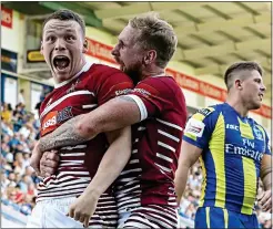  ??  ?? IT’S WIDE OPEN: Liam Marshall (left) celebrates his try for Wigan