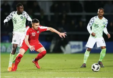  ?? Photo: AFP ?? Serbia’s striker Dusan Tadic (C) vies with Nigeria’s midfielder­s Wilfred Ndidi (L) and Joel Obi during the internatio­nal friendly match at the Hive stadium in Barnet, north London yesterday.