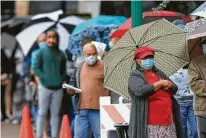  ?? Jason Fochtman / Staff photograph­er ?? Citizens bundle up in 50-degree, rainy weather to vote Friday at the Lee G. Alworth Building in Conroe.