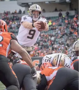  ?? BRYAN WOOLSTON/AP ?? Quarterbac­k Drew Brees threw for three touchdowns and snuck in for another in the Saints’ laugher against the host Bengals.