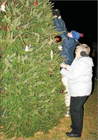  ?? MARTHA GEHRINGER — FOR DIGITAL FIRST MEDIA ?? Dave and Eleanor Ritter place ornaments on the Bally borough Christmas tree. For additional photos please turn to Page A6.