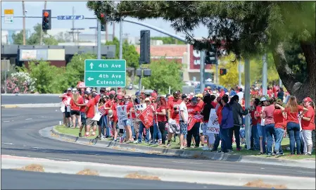  ?? PHOTOS BY RANDY HOEFT/YUMA SUN ?? Buy these photos at YumaSun.com PARTICIPAN­TS IN TUESDAY’S #REDFORED DEMONSTRAT­ION line the inside of the Big Curve near the intersecti­on of the 4th Avenue Extension and 32nd Street.