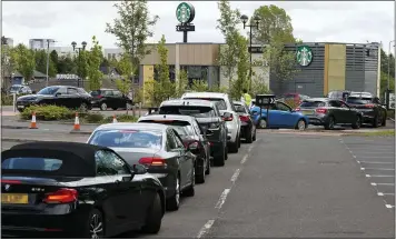  ??  ?? NO SHOW... AND LET’S GO: Empty lanes at Cockenzie test site but queues at Glasgow Starbucks