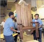  ?? Michael Perez
Associated Press ?? PRISONERS Rameen Perrin, left, and Evan Davis helped make a walnut chair for Pope Francis. Preparatio­ns for his visit have been underway for months.