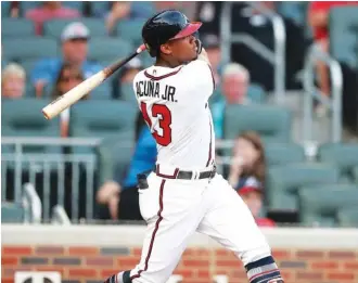  ?? ASSOCIATED PRESS PHOTOS ?? The Atlanta Braves’ Ronald Acuna Jr. hits a leadoff home run in the first inning of Tuesday’s home game against the Miami Marlins. The Braves won 10-6.
