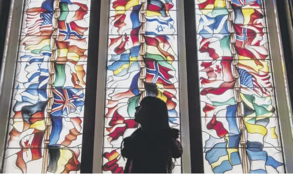  ??  ?? 0 A stained glass memorial window in Lockerbie Town Hall depicting flags from all the nations that lost citizens in the bombing