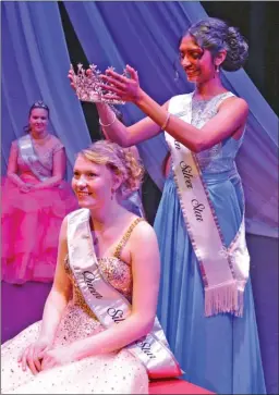  ?? WAYNE EMDE/Special to The Okanagan Weekend ?? Queen Silver Star 58, Angitha Mriduraj, places the crown on Haley Rakos, who, as Queen Silver Star 59, will reign over the Vernon Winter Carnival. Madison Barrett was crowned Princess Silver Star and, in addition to being voted Miss Congeniali­ty by the other candidates, earned scholarshi­ps for placing second in the Talent Showcase, first in the Knowledge of Vernon test and first in the speech contest. Ninety-eight events are scheduled in Vernon and at Silver Star Mountain Resort during the 10-day winter festival.