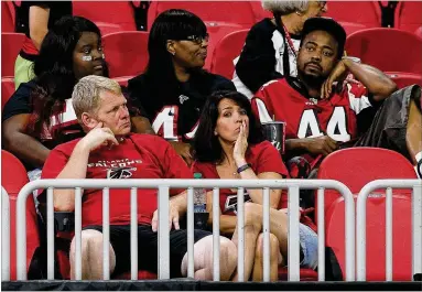  ?? CURTIS COMPTON / CCOMPTON@AJC.COM ?? Falcons fans sit dejected in the stands after falling 43-37 in overtime to the Saints at Mercedes-Benz Stadium in September. The Falcons also lost at New Orleans on Thanksgivi­ng night.