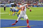  ?? JAYNE KAMIN-ONCEA / AP ?? Kansas City Chiefs tight end Travis Kelce (right) celebrates a touchdown in front of dejected Los Angeles Chargers defenders Sunday in Inglewood, Calif.