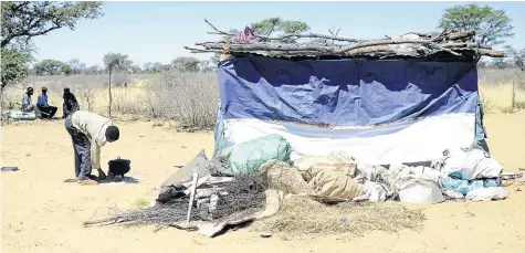  ??  ?? Shack dweller Sueman Mogwase prepares supper for his family who live in a plastic shack structure in Piet Plessis, North West, where poverty levels are the fourth highest in the province.