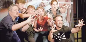  ?? GRAVITAS VENTURES ?? Andre Gower, right front, poses with “Monster Squad"“fans in his documentar­y “Wolfman's Got Nards.”